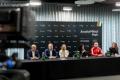 Uczestnicy konferencji siedzą przy stole. 
