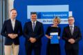 Osoby wręczające oraz beneficjenci odbierający listy gratulacyjne. 