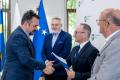 Uczestnicy uroczystości odbierają listy gratulacyjne. 