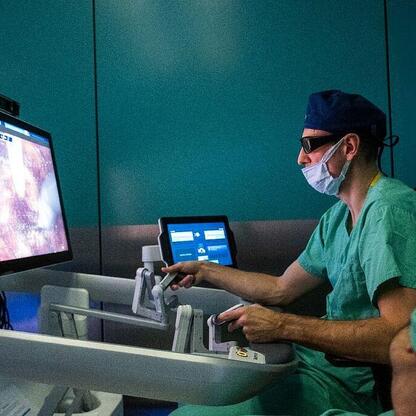 Dwa medycy w zielonych szortach i kaskach, pracujący z systemem robotycznym HUGO RAS w nowoczesnym szpitalu. (wygenerowano przez AI)