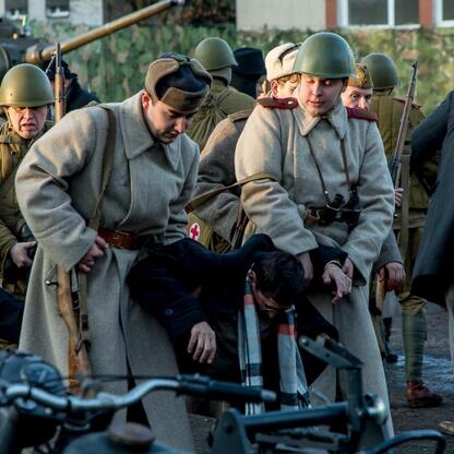 Historia i pamięć. Grupa w mundurach historycznych inspektuje sprzęt, uczestnicząc w rekonstrukcji Tragedii Górnośląskiej. (wygenerowano przez AI)
