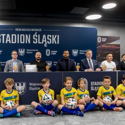 Konferencja prasowa przed meczem Ronaldinho Show, gdzie Rafał Adamczyk, członek zarządu Województwa Śląskiego, omawia przygotowania do spotkania z legendami piłki nożnej. (wygenerowano przez AI)