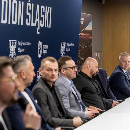 Konferencja prasowa przed meczem Ronaldinho Show na Stadionie Śląskim, gdzie Rafał Adamczyk omawia znaczenie wydarzenia dla regionu. (wygenerowano przez AI)