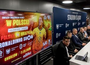 Konferencja prasowa przed meczem Ronaldinho Show na Stadionie Śląskim, gdzie Rafał Adamczyk omawia znaczenie wydarzenia. (wygenerowano przez AI)