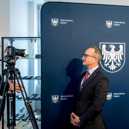 Wicemarszałek Województwa Śląskiego Grzegorz Boski podczas formalnego wywiadu na Jasnogórskim Zlotie Rowerowym. (wygenerowano przez AI)