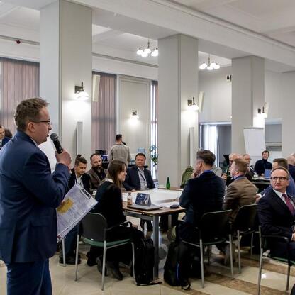 Wicemarszałek Grzegorz Boski prowadzi spotkanie w Silesia Marshal's Office, omawiając plany dla Zintegrowanej Sieci Kolejowej. (wygenerowano przez AI)