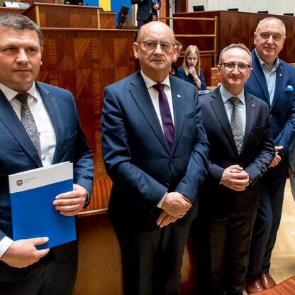 Grzegorz Boski, wicemarszałek, wręcza umowy na inwestycje w ramach Inicjatywy Sołeckiej. (wygenerowano przez AI)