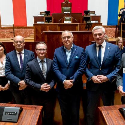 Grzegorz Boski, wicemarszałek, prezentuje dokumenty, podczas uroczystości w Sali Sejmiku Śląskiego. (wygenerowano przez AI)