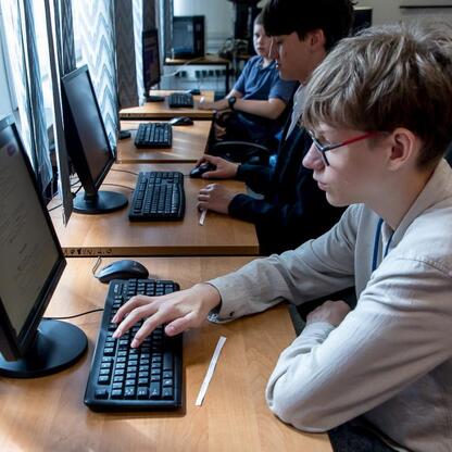 Grupa uczniów uczestniczy w IT Fitness Test, cyfrowym sprawdzianie kompetencji cyfrowych. (wygenerowano przez AI)