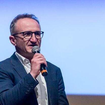 Grzegorz Boski, wicemarszałek Województwa Śląskiego, przemawia na konferencji o bezpieczeństwie drogowym i hejcie wśród młodzieży. (wygenerowano przez AI)