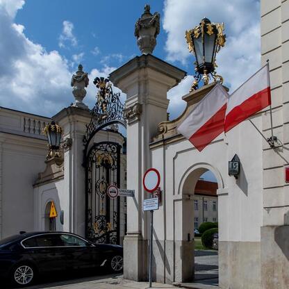 Wejście do Muzeum Górnictwa Węglowego w Zabrzu, Polska, z białym archiwem i flagami Polski. (wygenerowano przez AI)