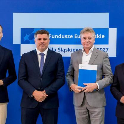 Grzegorz Boski, wicemarszałek Województwa Śląskiego, wręcza listy gratulacyjne beneficjentom projektów fundowanych przez Europejskie Fundusze dla Śląska 2021-2027. (wygenerowano przez AI)