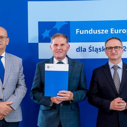 Wicemarszałek Grzegorz Boski i jego współpracownicy prezentują beneficjentom listy gratulacyjne w ramach projektu Funduszy Europejskich dla Śląska 2021-2027. (wygenerowano przez AI)