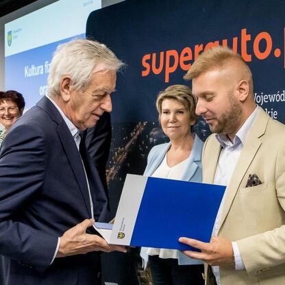 Ceremonia w Superauto.pl Stadion Śląski: prezentacja dokumentu przez przedstawiciela lokalnej administracji. (wygenerowano przez AI)