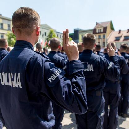 Grupa policjantów w mundurach z napisem 