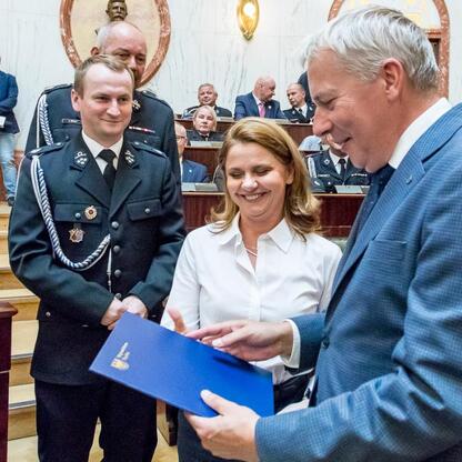 Marszałek Wojciech Saługa wręcza certyfikat nowym strażakom w Śląsku. (wygenerowano przez AI)