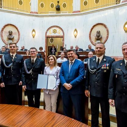 Oficjalna uroczystość wręczenia promes na dofinansowanie nowych wozów ratowniczo-gaśniczych dla OSP w regionie Śląskim. (wygenerowano przez AI)