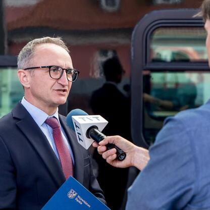 Grzegorz Boski, wicemarszałek Województwa Śląskiego, omawia nowe pociągi Impuls 2. (wygenerowano przez AI)