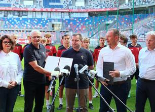 Wojciech Saługa, Piotr Borys i Ewa Weber inspekcują stadion Górnika Zabrze, wspierając rozwój sportu w Śląsku. (wygenerowano przez AI)