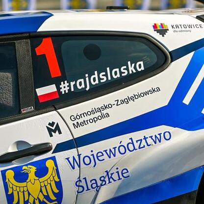Rally car adorned with decals and logos, featuring 
