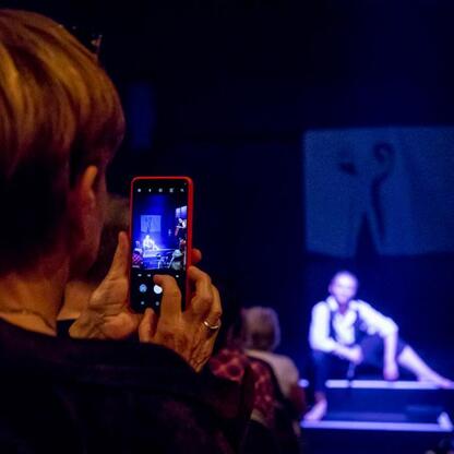 Audience watches a performance titled 