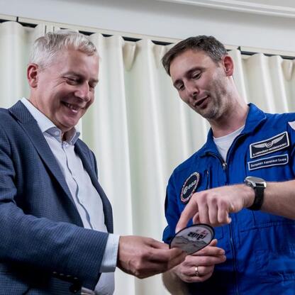 Wojciech Saługa i Sławosz Uznański-Wiśniewski omawiają misję IGNIS w Śląskim Planetarium. (wygenerowano przez AI)