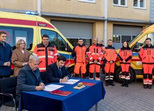 Marszałek Wojciech Saługa, wraz z dyrektorami i marszałkiem województwa, podpisuje umowę na nowe ambulansy dla Wojewódzkiego i Rejonowego Pogotowia Ratunkowego. (wygenerowano przez AI)