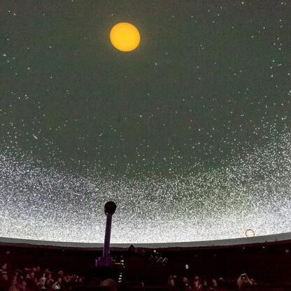 Wnętrze Planetarium Śląskiego podczas koncertu z wykorzystaniem pełni możliwości aparatury. (wygenerowano przez AI)