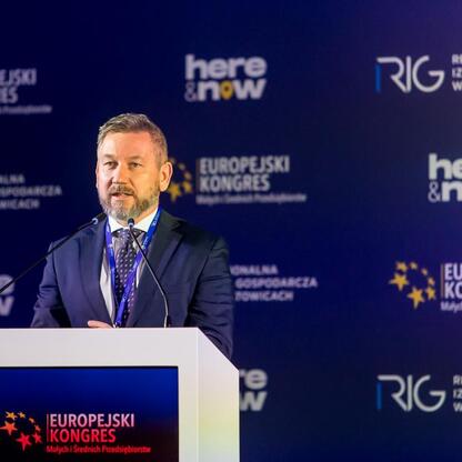 Podczas 15. edycji Europejskiego Kongresu Małych i Średnich Przedsiębiorstw w Katowicach, na podium mówiącym o rozwoju gospodarczym regionu. (wygenerowano przez AI)