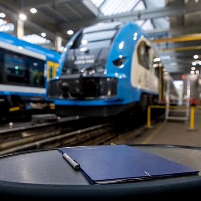Modern train maintenance facility with a focus on Koleje Śląskie fleet, symbolizing administrative and planning aspects of the project. (wygenerowano przez AI)