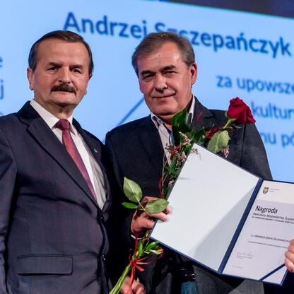 Dwóch mężczyzn otrzymuje nagrody za promowanie i ochronę kultury ludowej w Katowicach. (wygenerowano przez AI)