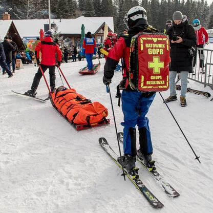 Ski patrollers in red jackets with 
