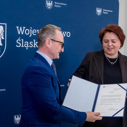 Grzegorz Boski, wicemarszałek Śląskiego Voivodztwa, wręcza symboliczne listy gratulacyjne beneficjentom projektów wodno-ściekowych. (wygenerowano przez AI)