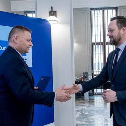 Rafał Adamczyk, członek zarządu województwa, wręcza listy gratulacyjne przedstawicielom otrzymania finansowania dla projektów edukacji przedszkolnej. (wygenerowano przez AI)