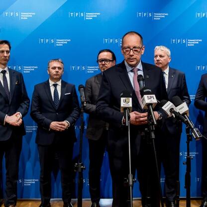 Marszałek Województwa Śląskiego Wojciech Saługa prowadzi konferencję prasową na tle logo TFS Towarzystwo Finansowe Silesia, oznaczając rozpoczęcie inwestycji w Silesia Bytom Park. (wygenerowano przez AI)
