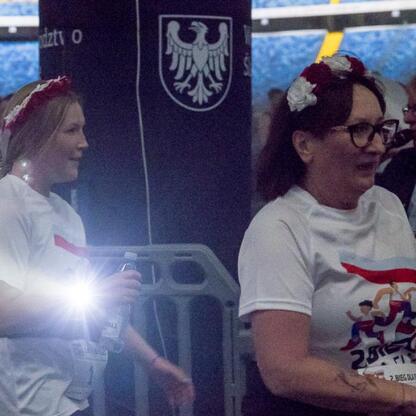 Dwie kobiety w biało-czerwonych koszulkach, siedzące na trybunach w Tauron Parku Śląskim, podczas 
