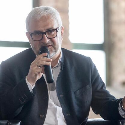 Konferencja o rewitalizacji przemysłowych terenów, gdzie przedstawiciele biznesu i kultury omawiają potencjał turystyczny i kulturalny. (wygenerowano przez AI)
