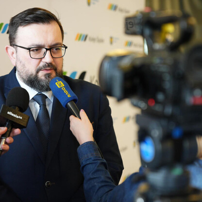 Na zdjęciu przedstawiono konferencję prasową z udziałem przedstawicieli Kolei Śląskich i Wojewódzkiego Pogotowia Ratunkowego w Katowicach, dotyczącą sukcesu promocji usług kolejowych podczas ferii szk (wygenerowano przez AI)