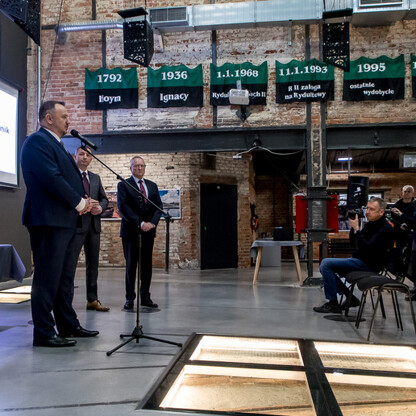 Formalne uroczystości w byłej kopalni, obecnie przekształconej w centrum kultury i edukacji. (wygenerowano przez AI)