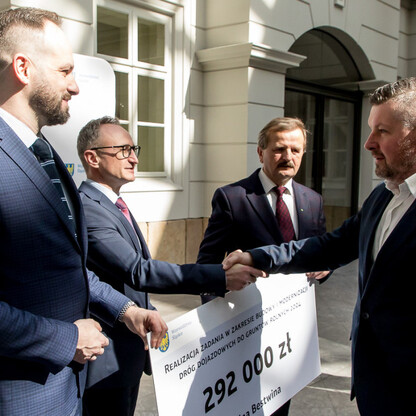 Wicemarszałek Grzegorz Boski przekazuje symboliczne czeki na modernizację dróg dojazdowych do gruntów rolnych w Silesia. (wygenerowano przez AI)